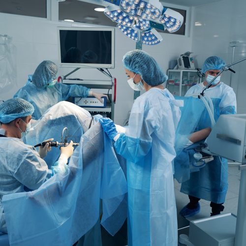 Four surgery specialist in operating theater treating patient Endometriosis